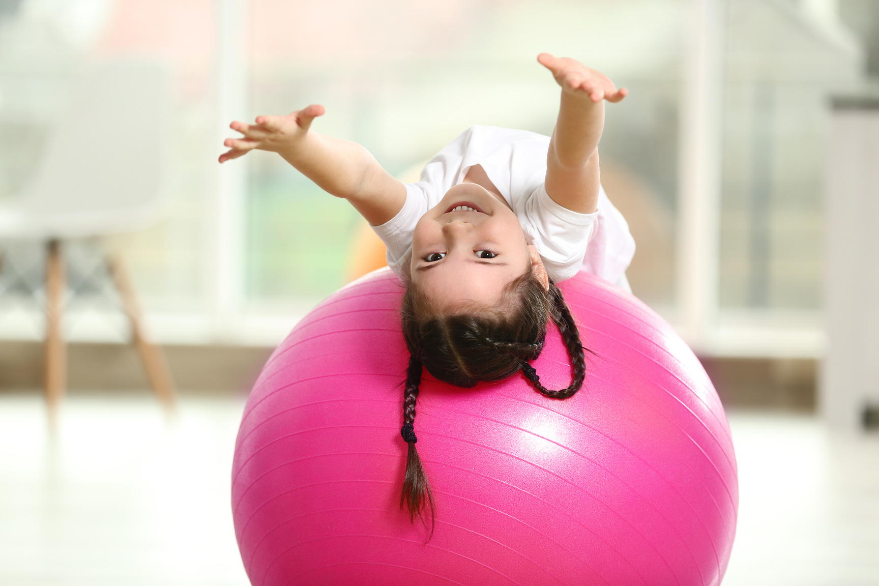 Little Cute Girl Doing Exercises on a Fitness Orb